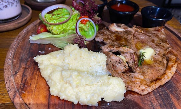 prime sirloin beef steak along with mash potatoes with delicious mushroom sauce and green salad onion new york sirloin