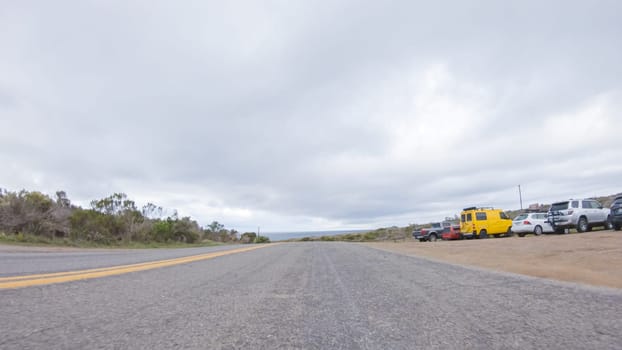 In this serene winter scene, a vehicle carefully makes its way along Los Osos Valley Road and Pecho Valley Road within Montana de Oro State Park.