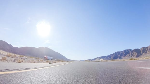 Embarking on a road trip from Nevada to California, driving on Highway 15 during the day offers scenic views and an exciting journey between states.