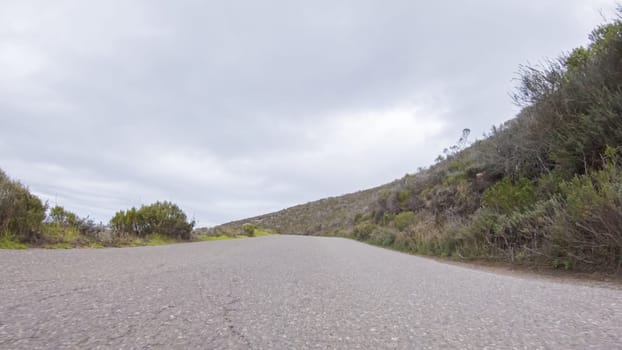 In this serene winter scene, a vehicle carefully makes its way along Los Osos Valley Road and Pecho Valley Road within Montana de Oro State Park.