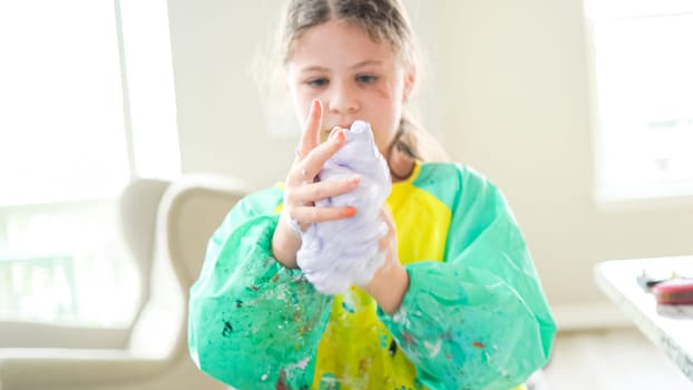 In a modern kitchen, a homeschooled girl is engrossed in creating homemade slime, a fun and educational hands-on project that enhances her creativity and problem-solving skills.