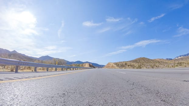 Embarking on a road trip from Nevada to California, driving on Highway 15 during the day offers scenic views and an exciting journey between states.