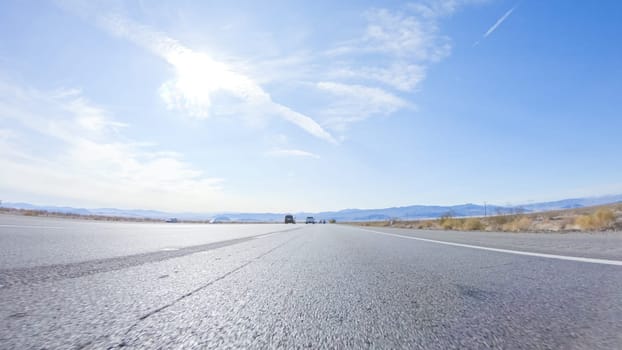 Embarking on a road trip from Nevada to California, driving on Highway 15 during the day offers scenic views and an exciting journey between states.