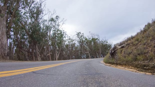 In this serene winter scene, a vehicle carefully makes its way along Los Osos Valley Road and Pecho Valley Road within Montana de Oro State Park.