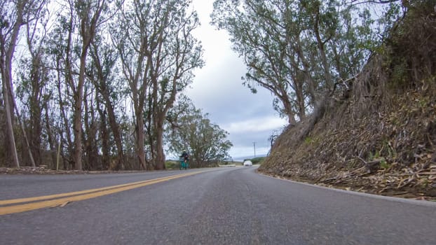 In this serene winter scene, a vehicle carefully makes its way along Los Osos Valley Road and Pecho Valley Road within Montana de Oro State Park.