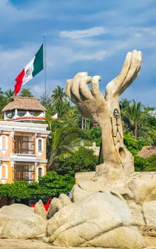 Puerto Escondido Oaxaca Mexico 04. October 2022 Hands made of stone rock statue sculpture on the beach in Zicatela Puerto Escondido Oaxaca Mexico.