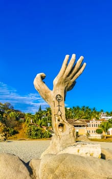 Puerto Escondido Oaxaca Mexico 01. December 2022 Hands made of stone rock statue sculpture on the beach in Zicatela Puerto Escondido Oaxaca Mexico.