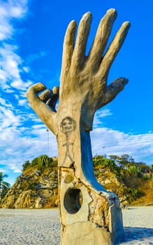 Puerto Escondido Oaxaca Mexico 01. December 2022 Hands made of stone rock statue sculpture on the beach in Zicatela Puerto Escondido Oaxaca Mexico.