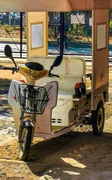 Puerto Escondido Oaxaca Mexico 16. January 2023 White tuk tuk tricycle TukTuks rickshaw in Zicatela Puerto Escondido Oaxaca Mexico.