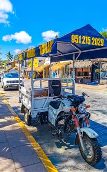 Puerto Escondido Oaxaca Mexico 24. March 2023 White tuk tuk tricycle TukTuks rickshaw in Zicatela Puerto Escondido Oaxaca Mexico.