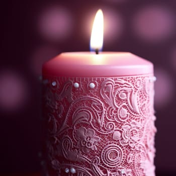 A lit red candle with decorative patterns and beads.