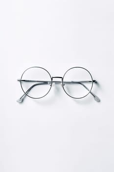 Round metal frame eyeglasses on a white background.