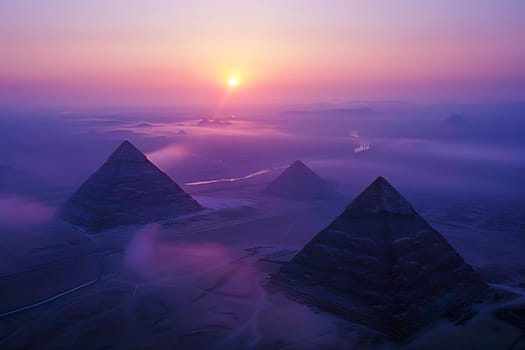 Aerial view of the Egyptian pyramids as the sun sets in the background.