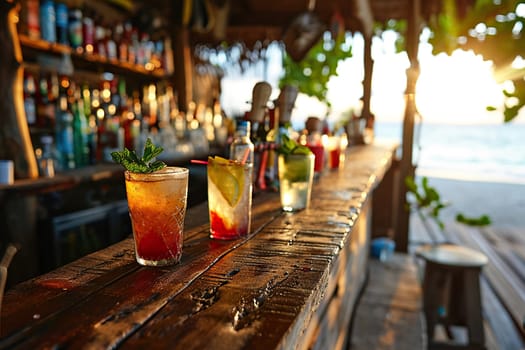 Wooden bar counter with summer cocktails on the seashore.