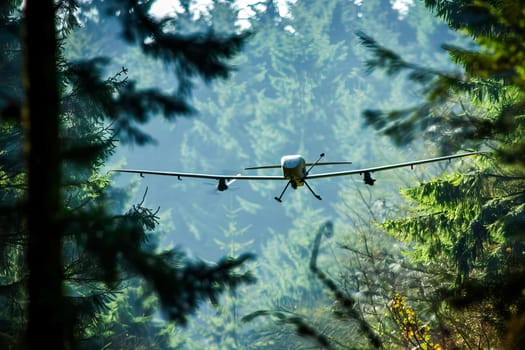 Military airplane flies over a dense forest filled with trees