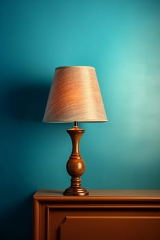 Vintage lamp on wooden dresser against teal background.