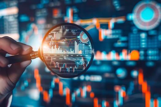 Close up of a hand holding a magnifying glass over a detailed stock chart for financial analysis.