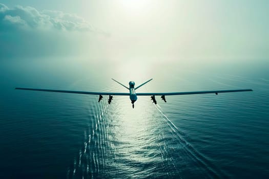 Military unmanned airplane flies above the ocean on a clear, sunny day.