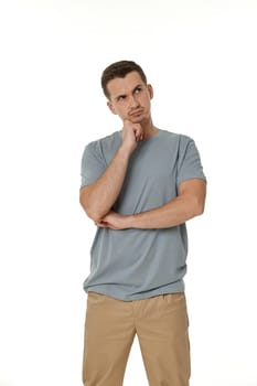 Young confused puzzled man isolated on white background