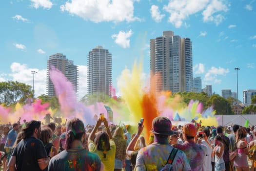 Revelers enjoy a Holi event in Sydney, Australia, captured mid-celebration as clouds of colorful powder fill the air. The festive atmosphere is palpable, with city buildings standing tall in the background.