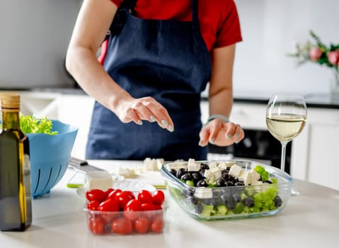 Housewife Puts Cheese In Bowl With Greek Salad Preparing Homemade Food