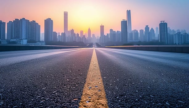 The perspective of the road against the background of sunset and the cityscape. High quality photo