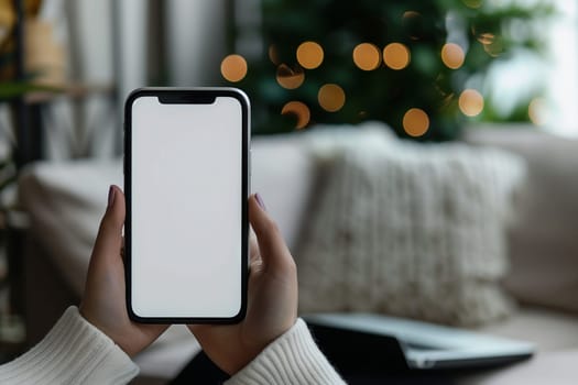 The woman is making a gesture with her finger on a communication device. She is holding a mobile phone with a white screen, using her thumb to interact with the gadget