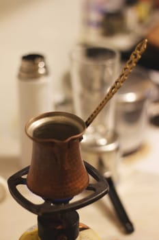 Step into a world of warmth and tradition as Greek coffee brews gently on a small gas burner, reminiscent of the beloved Turkish coffee ritual.