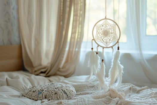 A dream catcher hangs above a bed near a window in a cozy bedroom with wooden flooring. The window treatment with curtains adds a touch of comfort to the interior design of the room