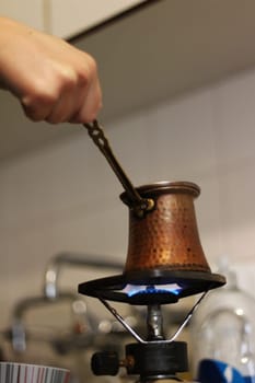 Step into a world of warmth and tradition as Greek coffee brews gently on a small gas burner, reminiscent of the beloved Turkish coffee ritual.