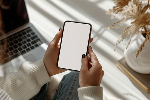 The woman is holding a communication device with a white screen in her hands, possibly a gadget or personal computer, making a gesture with her finger