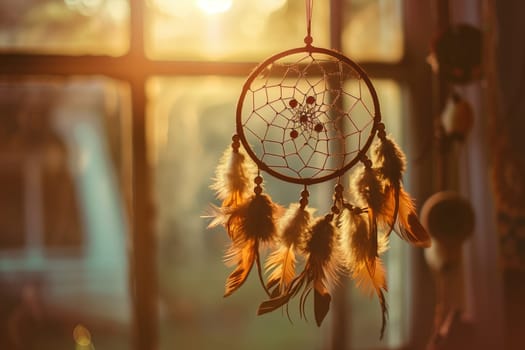 An Amber dream catcher with Twig accents hangs gracefully from a Window at sunset, casting beautiful Tints and shades on the Glass, Metal, Wood, Plant, Flower, and Petal decorations