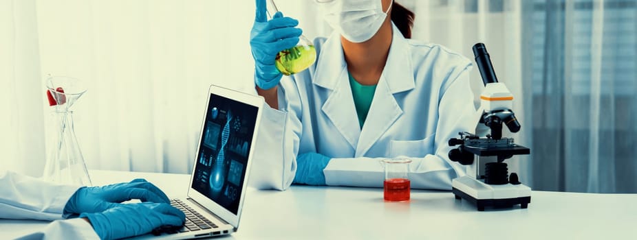 Laboratory research team advance healthcare with scientific expertise, laboratory equipment, and innovative medical biotechnology software, researching new medicines and developing cure.Panorama Rigid