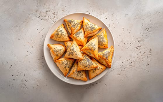 Top View Triangular Hamantaschen With Poppy Seed Filling On White Plate On Concrete Background. Traditional Jewish Pastry, Bakery Ai Generated. Purim Holiday. Horizontal Plane