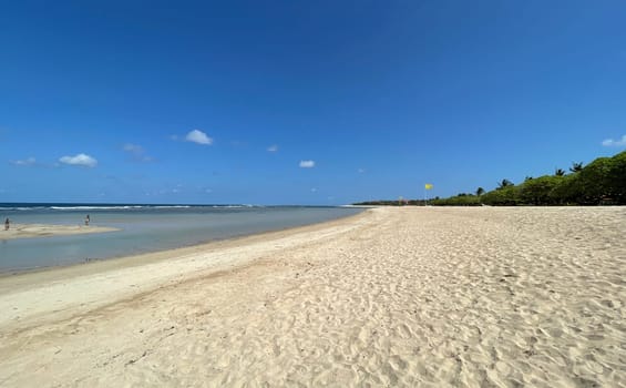 Tropical beach in sunny weather with blue sky and white sands Panorama of a beautiful white sand beach and turquoise water, Holiday summer beach background Wave of the sea on the sand beach