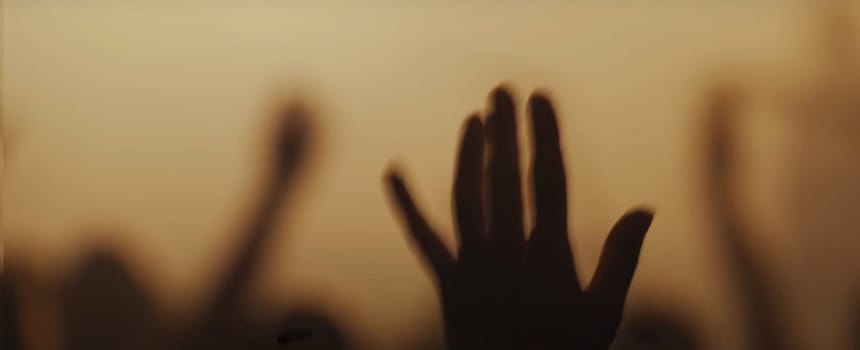 Blurry background picture of hand reaching out for God's help, good for your multimedia content background or card design