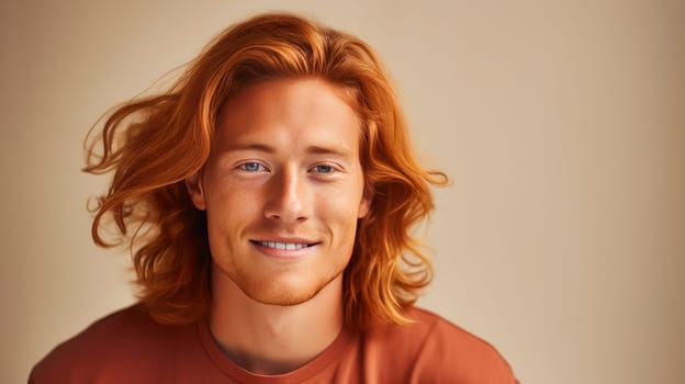 Handsome young male guy smile Asian with long red hair, on creamy beige background, banner, copy space, portrait. Advertising of cosmetic products, spa treatments, shampoos and hair care products, dentistry and medicine, perfumes and cosmetology men