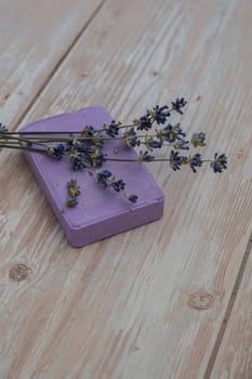 Handcrafted purple lavender soap with lavender flowers. Natural hydrating moisturiser softness cosmetic. Organic calming beauty skincare product. Herbal self care wellness alternative soap. Copy space