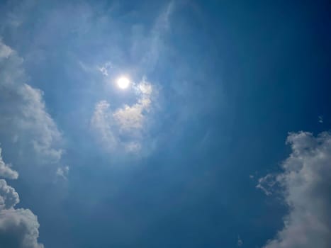 Heavenly white clouds on the blue sky with the sun appeared perfect for multimedia texture or background