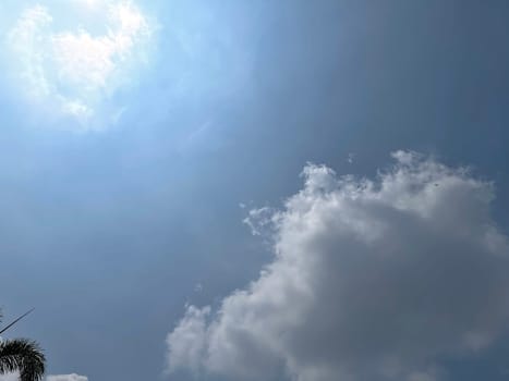 Heavenly white clouds on the blue sky with the sun appeared perfect for multimedia texture or background