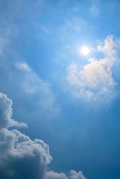 Heavenly white clouds on the blue sky with the sun appeared perfect for multimedia texture or background