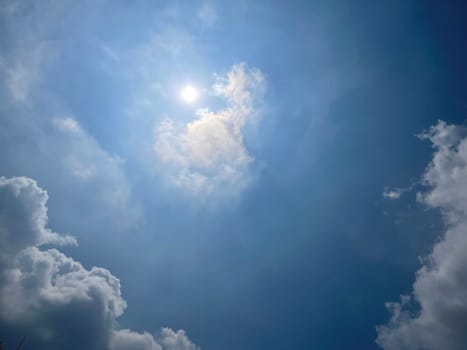 Heavenly white clouds on the blue sky with the sun appeared perfect for multimedia texture or background