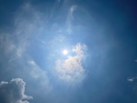 Heavenly white clouds on the blue sky with the sun appeared perfect for multimedia texture or background