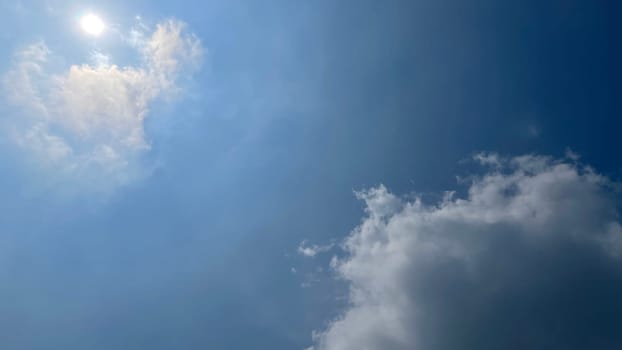 Heavenly white clouds on the blue sky with the sun appeared perfect for multimedia texture or background