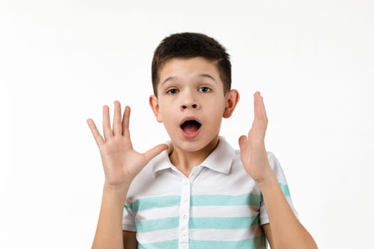 happy surprised little child boy in t-shirt looking to camera on white background. Human emotions and facial expression