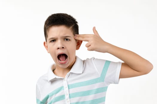 little boy in t-shirt shooting in temple with hand on white background.