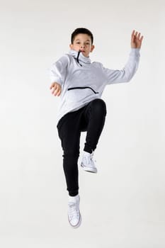 emotional little boy jumping on white studio background.