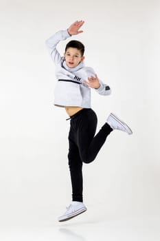 emotional little boy jumping on white studio background.