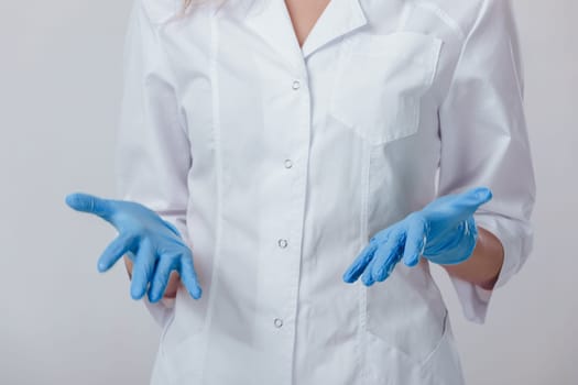 Woman doctor hands in medical latex blue gloves, close-up