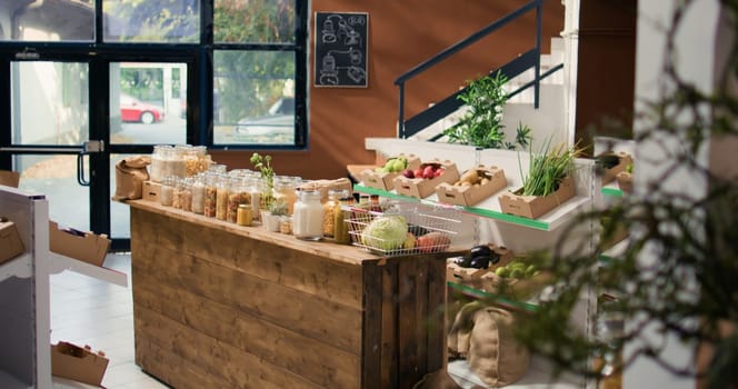 Bulk products in reusable glass jars used by zero waste small business store to lower climate impact and support sustainable lifestyle. Local supermarket with pantry supplies.